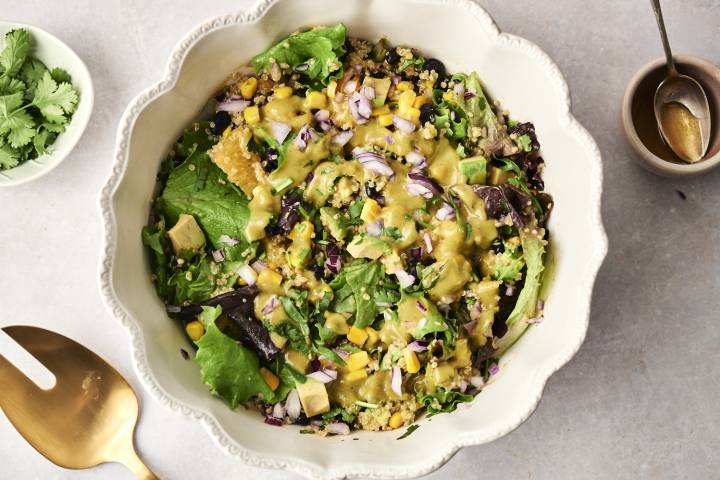 A fresh and flavorful Mexican quinoa salad with black beans, corn, avocado, and a tangy cilantro dressing.