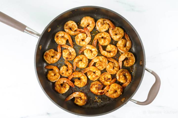 Cooked cajun shrimp in a skillet.