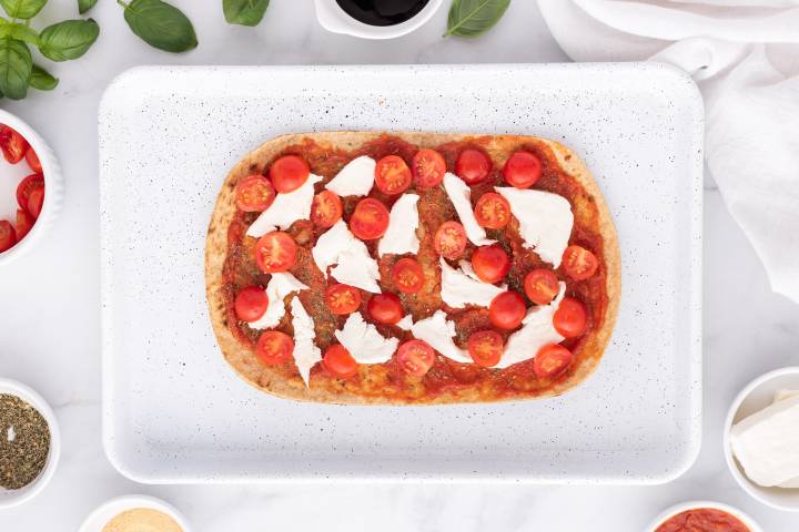 Flatbread topped with marinara sauce, cherry tomatoes, and fresh mozzarella.