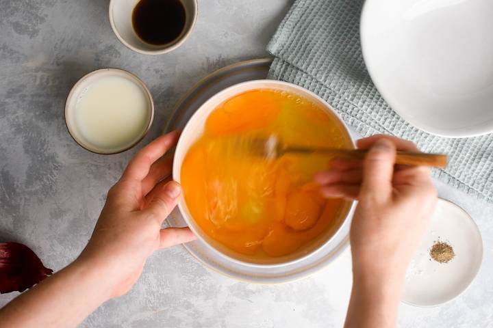 Eggs being whisked in a bowl.