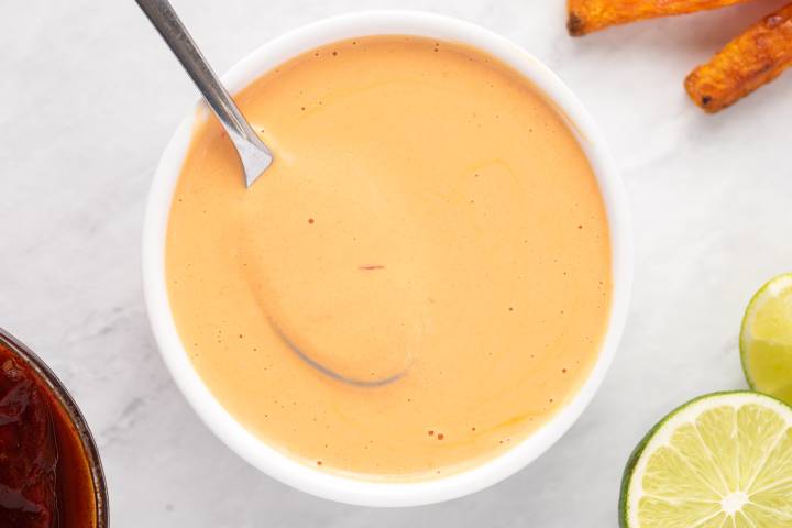 Chipotle sauce in a white bowl with a spoon.