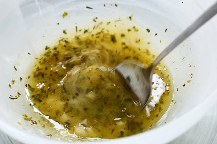 Butter, garlic, lemon, and Italian seasoning in a small bowl.