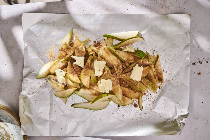 Sliced pears, butter, cinnamon, brown sugar, and dried ginger in a foil packet.