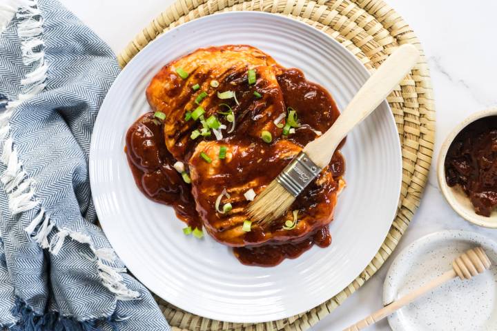 Grilled chicken bring brushed with honey chipotle sauce.