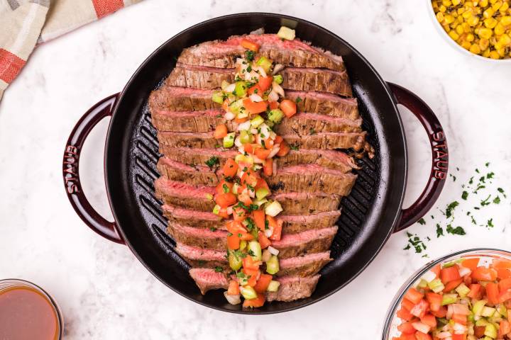 Grilled and marinated flank steak on a grill pan.