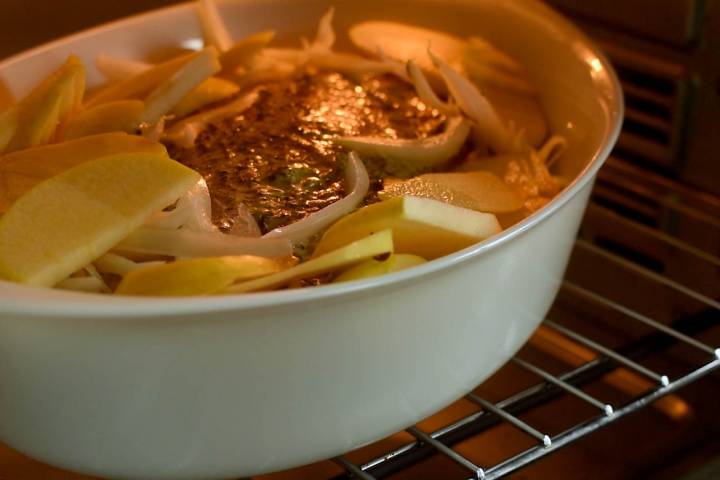 Pork and apples roasting in the oven.