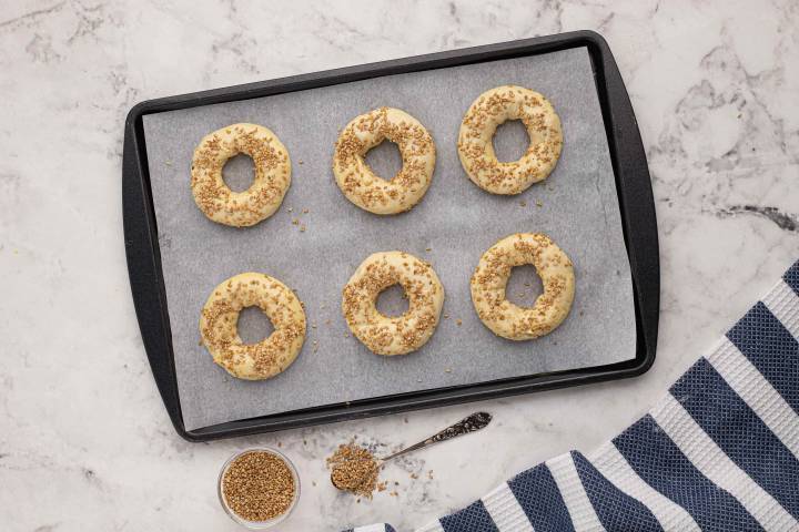 Two ingredient dough bagels with sesame seeds and egg wash before going into the oven.