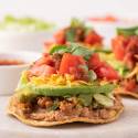 Ground turkey tostadas with beans, ground turkey, avocado, tomatoes, cheese, and cilantro.