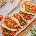 Ground chicken tacos with seasoned ground chicken, tomatoes, and lettuce in flour tortillas.