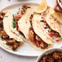 Mediterranean chicken tacos with cucumber tomato salsa, feta cheese, olives, and tzaztziki.