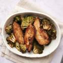 Sheet pan peanut chicken and broccoli with peanut sauce on a baking sheet.