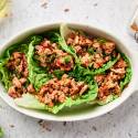 Turkey taco lettuce wraps with tomatoes, shredded cheese, ground turkey, and avocado. 