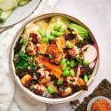 Vegetarian sushi bowl with avocado, rice, seaweed, edamame, and tofu.