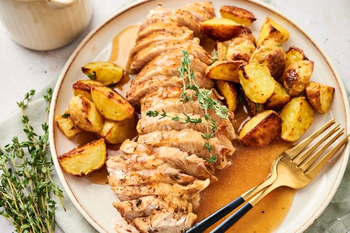 Instant pot turkey tenderloin with potatoes and gravy on a plate.