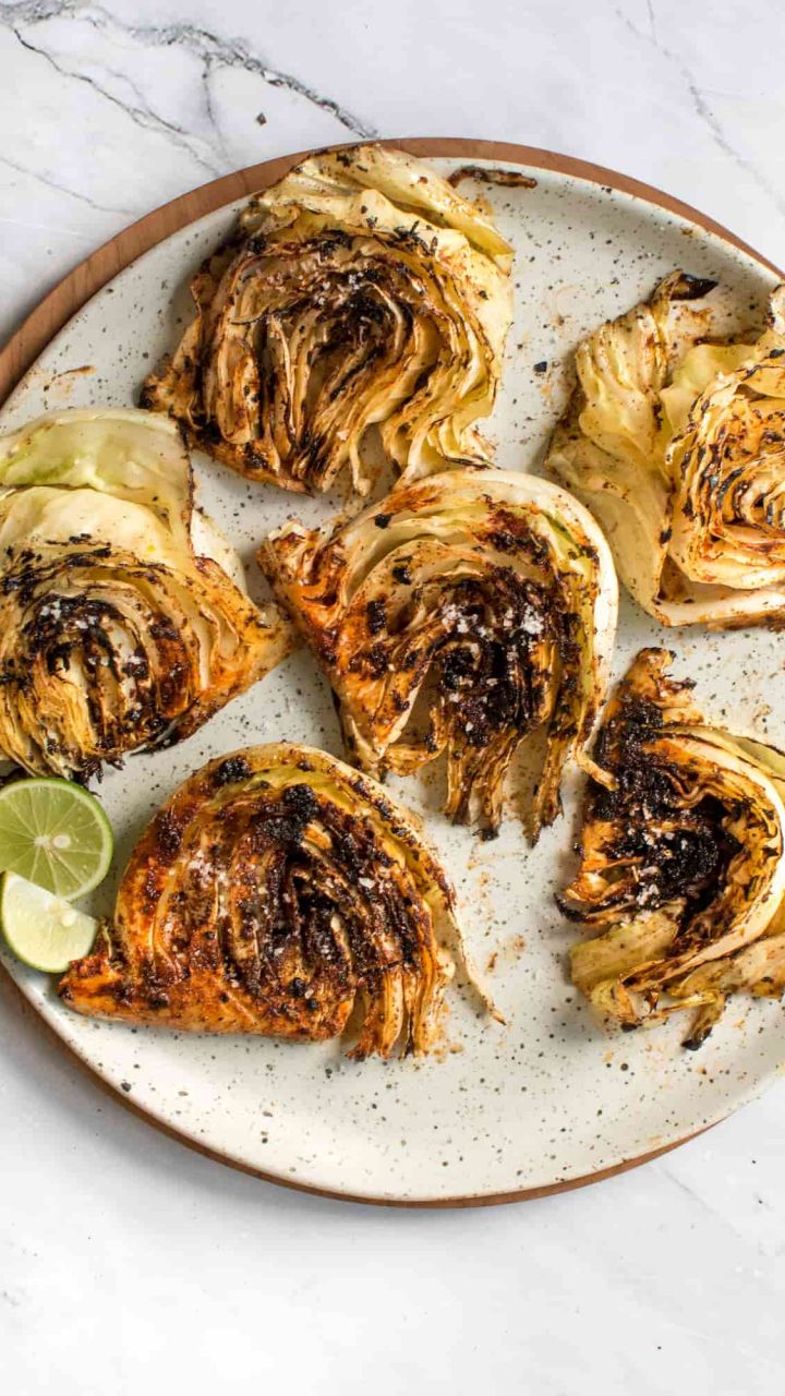 Grilled cabbage steaks top on gas grill