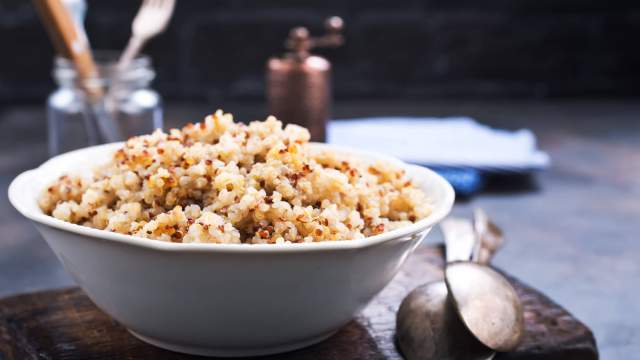 Ultimate guide to quinoa with a picture of cooked quinoa in a bowl.