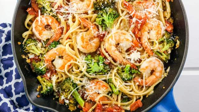 Shrimp and broccol pasta with lemon and garlic in a skillet.