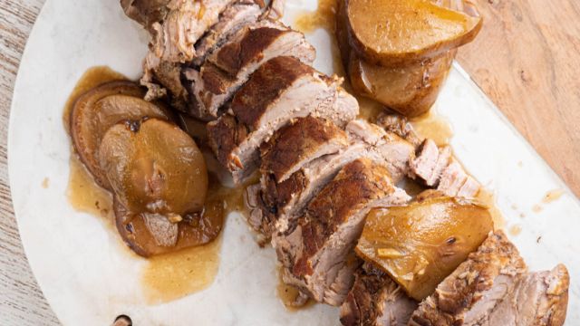 Slow cooker balsamic honey pork tenderloin with cooked pears on a plate.