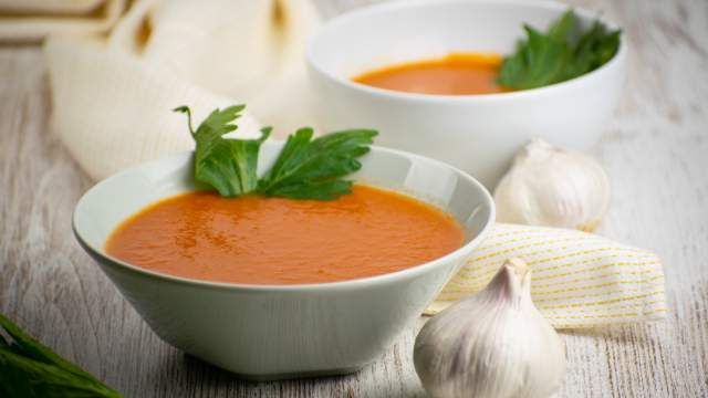 Slow cooker tomato soup with chipotle flavors in a bowl with a napkin.