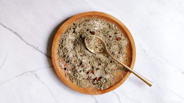 Italian seasoning mixed on a plate with oregano, basil, rosemary, thyme, garlic powder, and red pepper flakes. 