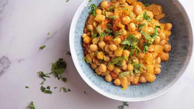 Slow cooker sweet and sour chickpeas with pineapple, red pepper, and cilantro in a bowl.