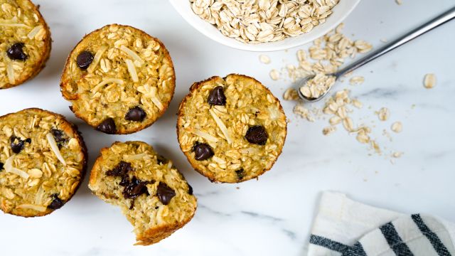 Banana oatmeal muffins with chocolate chips on a marble board.