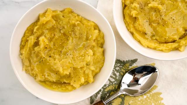 Butternut squash mashed potatoes with a spoon and napkin.