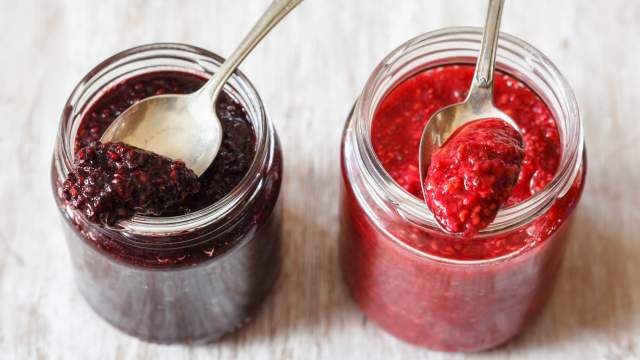 Chai seed jam with fresh berries in glass jars.