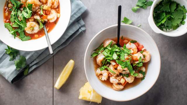 Cóctel de camarones with shrimp marinated in tomato and lime juice served with cilantro.