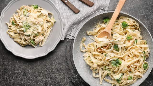 Chicken and broccoli pasta in a bowl with a creamy Parmesan sauce.