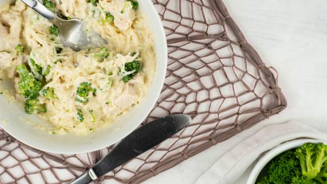 Creamy Parmesan Spaghetti Squash with chicken breast and broccoli in a bowl.