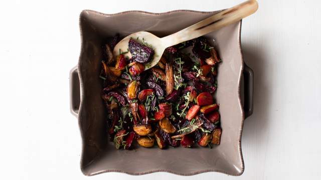 Easy roasted beets with balsamic vinegar and honey in a dish with fresh herbs.