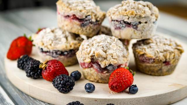 Frozen oatmeal cups piled up with berries.