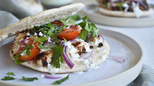 Grilled chicken souvlaki marinated in lemon and garlic served in a pita with tzatziki, tomatoes, red onions, and parsley.