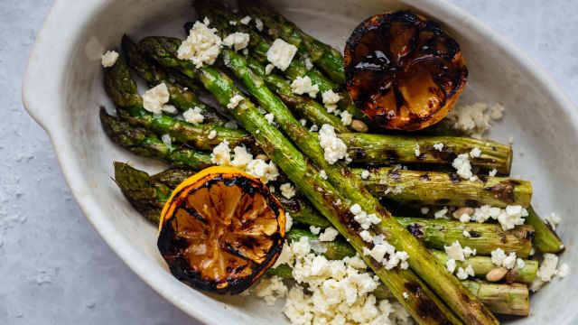 Grilled lemon asparagus topped with crumbled feta cheese and served with grilled lemon halves.