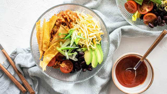 Turkey taco salad with ground turkey, tomatoes, black beans, cheddar cheese, and crispy tortilla strips.