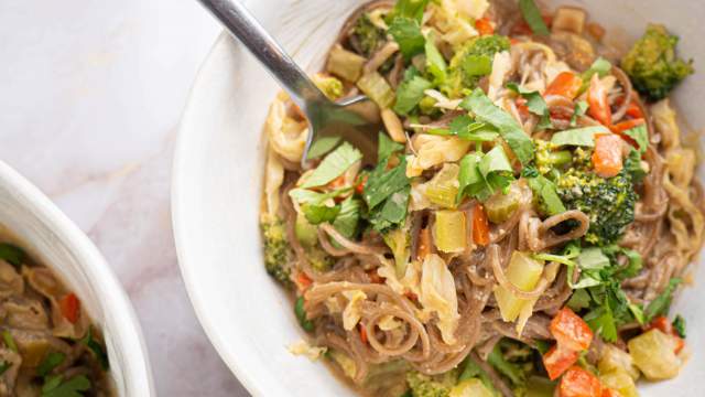 Healthy peanut noodles with broccoli, celery, carrots, and peppers over soba noodles in peanut sauce.