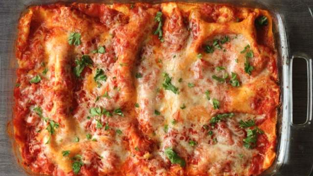 Healthy zucchini lasagna in a glass baking dish with melted cheese on top.