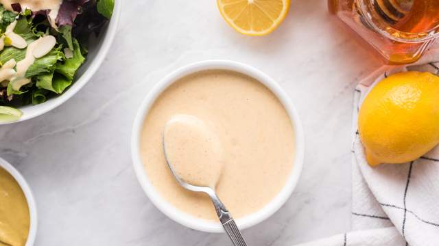 Honey mustard with Greek yogurt, honey, and Dijon mustard in a small bowl with green salad on the side.