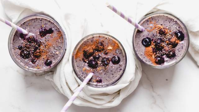 Blueberry banana protein smoothie with fresh blueberries, chia seeds, and cinnamon.