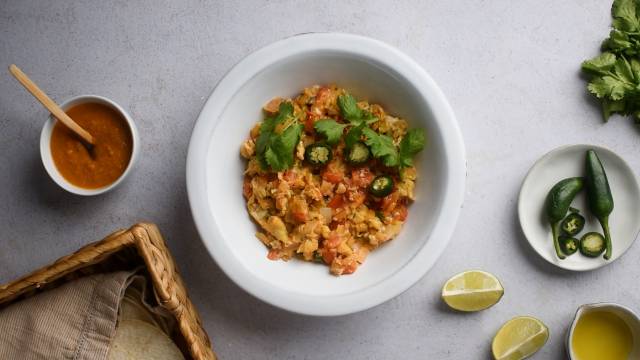 Huevos a la mexicana with scrambled eggs, tomatoes, onions, jalapenos, and cilantro in a bowl.