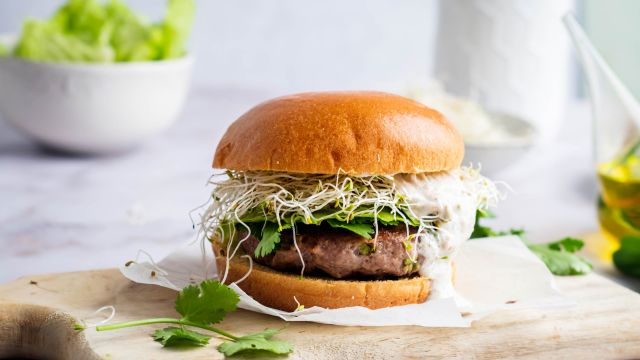 Jalapeno cheddar burgers with lettuce, tomato, and onion served on a hamburger bun, 