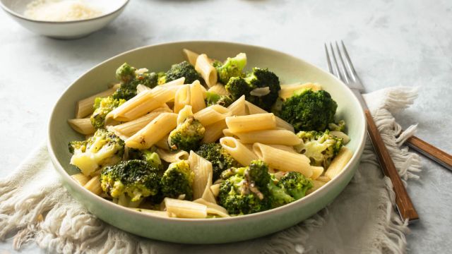 Lemon broccoli pasta in a bowl with fresh lemon juice, garlic, and Parmesan cheese.