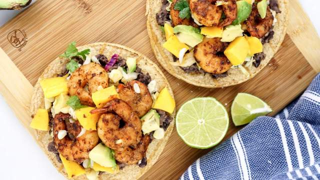 Shrimp Mango Tostadas with black beans, cabbage, corn, mango, cilantro, and avocado.