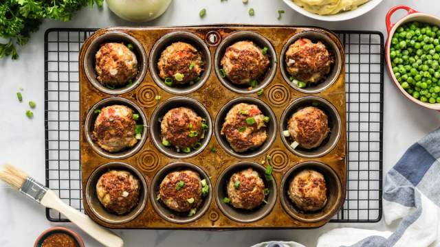 BBQ Meatloaf muffins with ground turkey, red pepper, celery, and a barbecue and mustard sauce in a muffin tin.