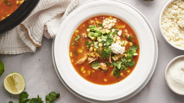 Mexican chicken soup with shredded chicken, corn, onions, avocado, cilantro, and queso fresco.