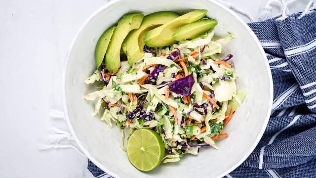 Mexican coleslaw with lime Greek yogurt dressing with cabbage, carrots, cilantro, and avocado.