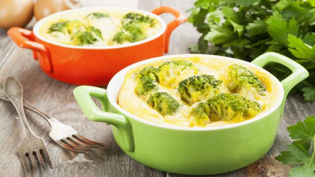 Microwave omelet with broccoli and cheese in a green bowl.