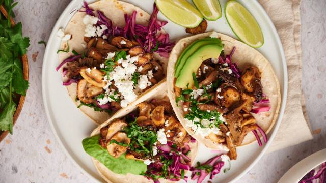 Mushroom tacos with crispy mushrooms, red cabbage slaw, queso fresco, and avocado on corn tortillas.