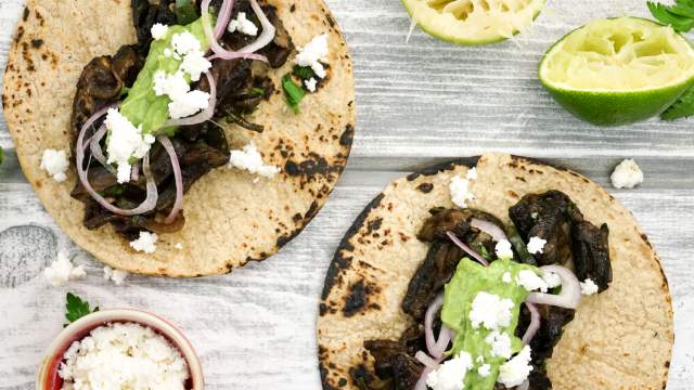 Portobello mushroom tacos with avocado salsa on corn tortillas.